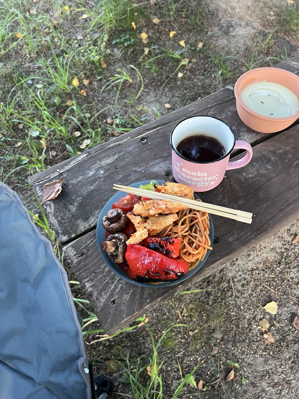 A full plate of grilled chicken, vegetables and whole-wheat pasta beside Earl Grey tea and chopsticks