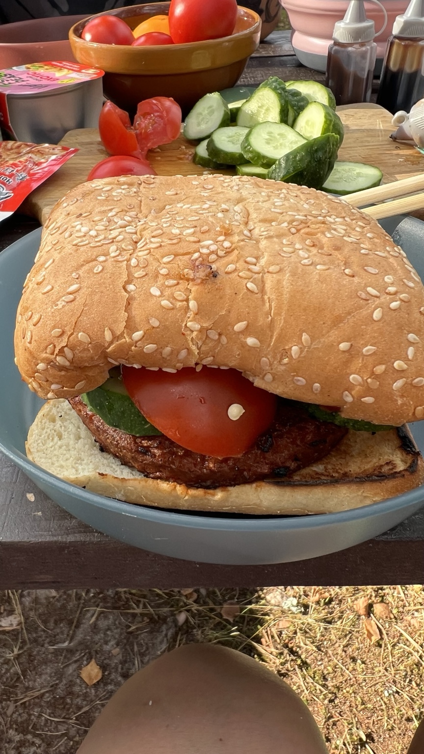A large Beyond Meat burger with fresh cucumber and tomato