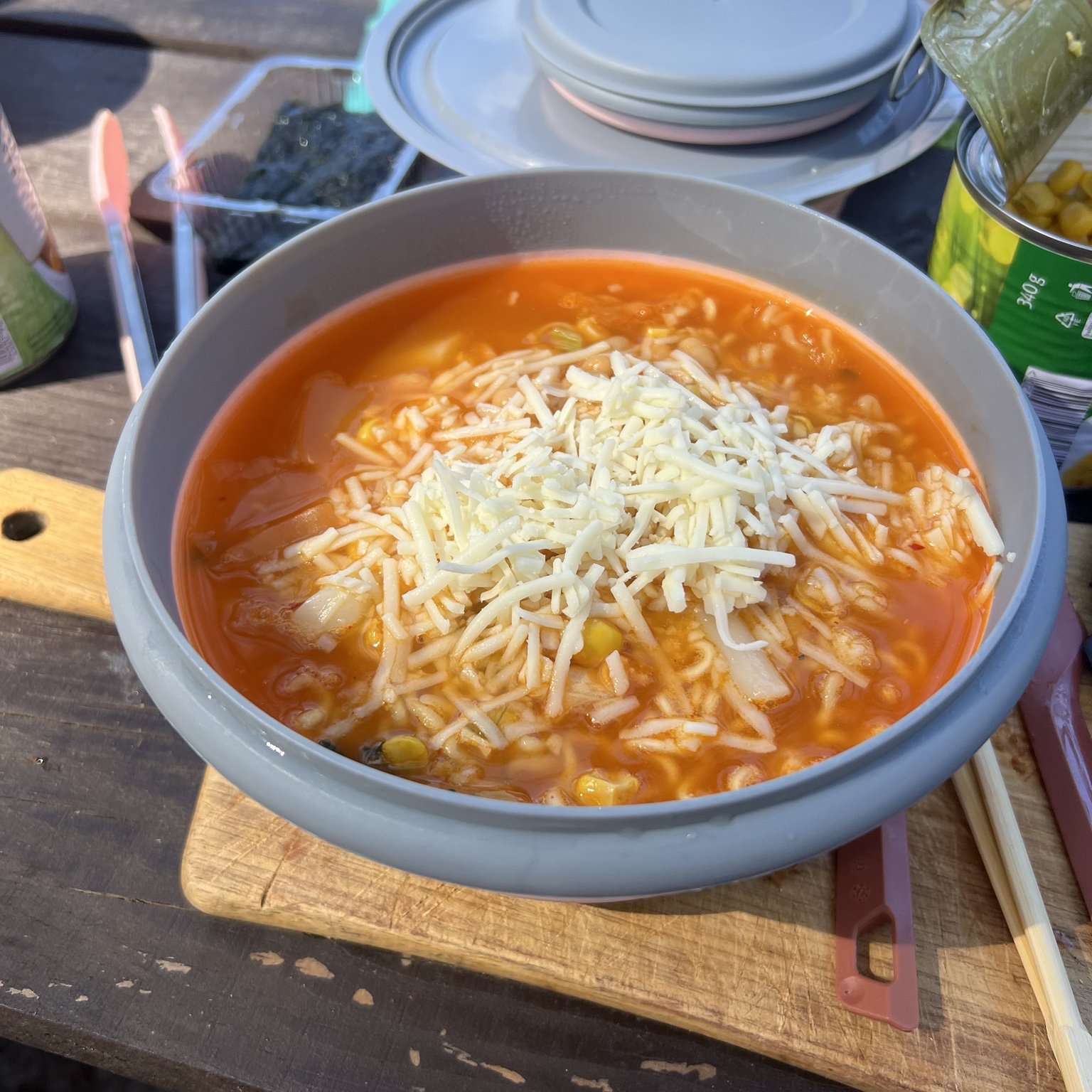 A large bowl of ramen topped with vegan cheese